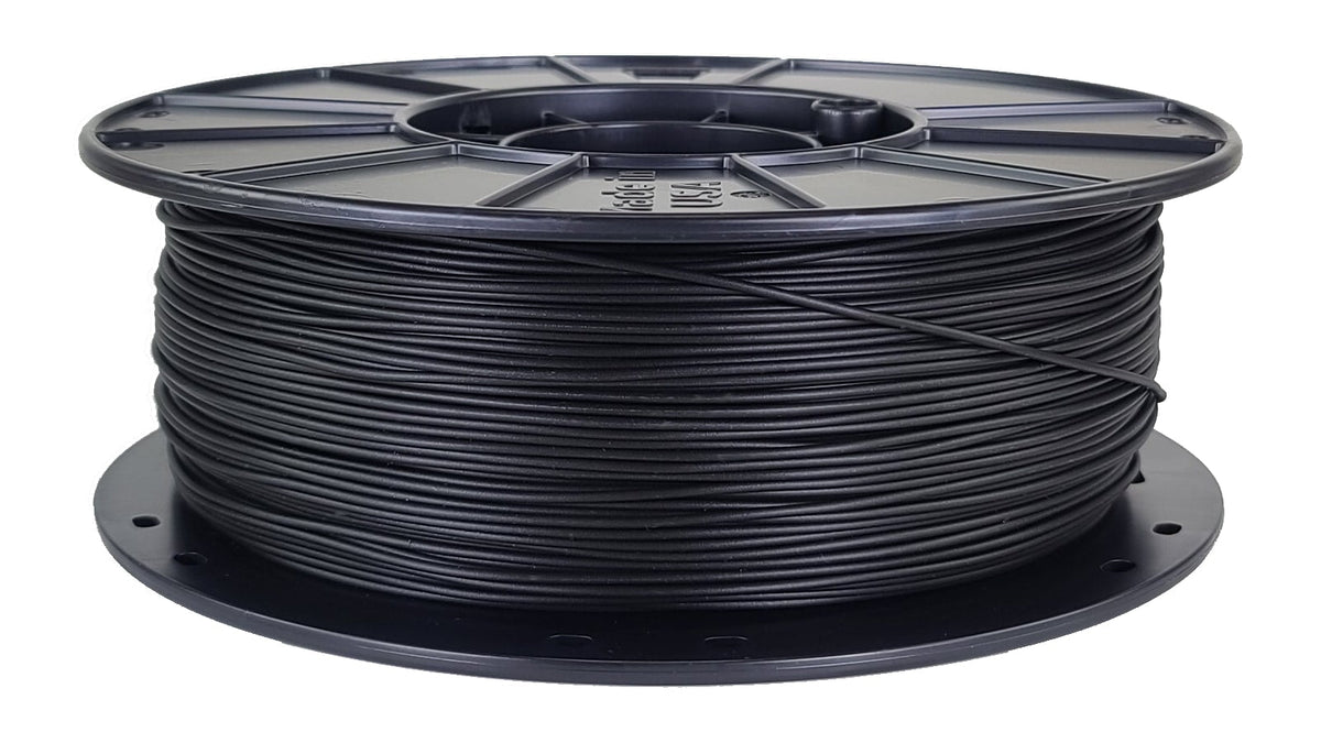 Spool of black filament on a white background