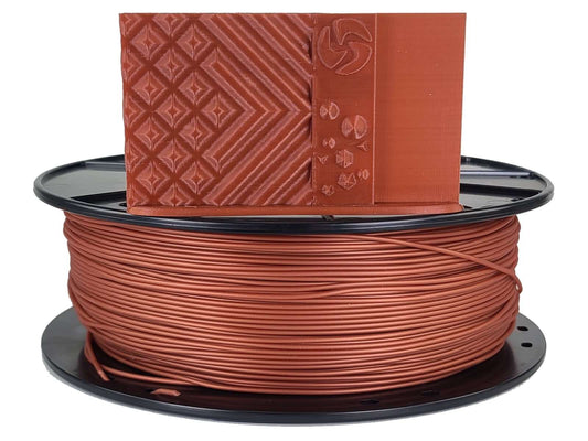Spool of brown filament with a sample piece on top against a white background