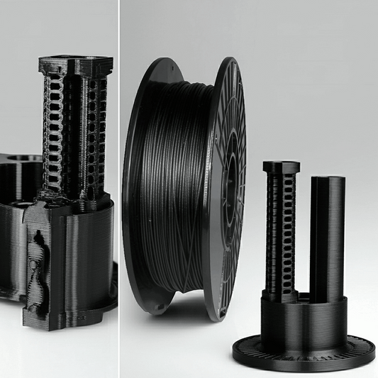Black 3D printing filament spool with nozzles on a light gray background