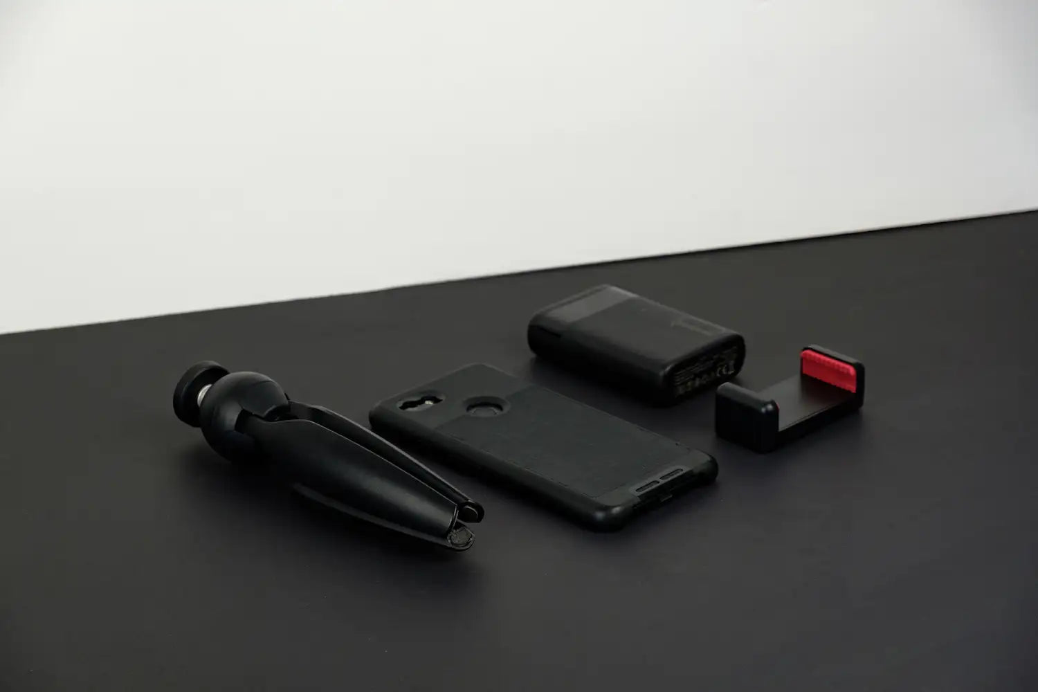 Black electronic device with components on a dark surface