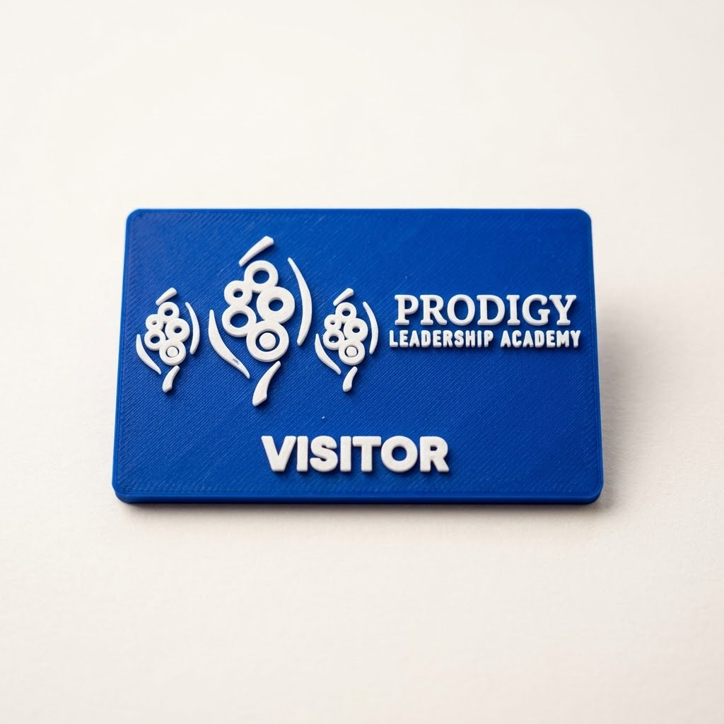 Blue 3D printed name badge with raised white logo and VISITOR text, made the same way as our business cards