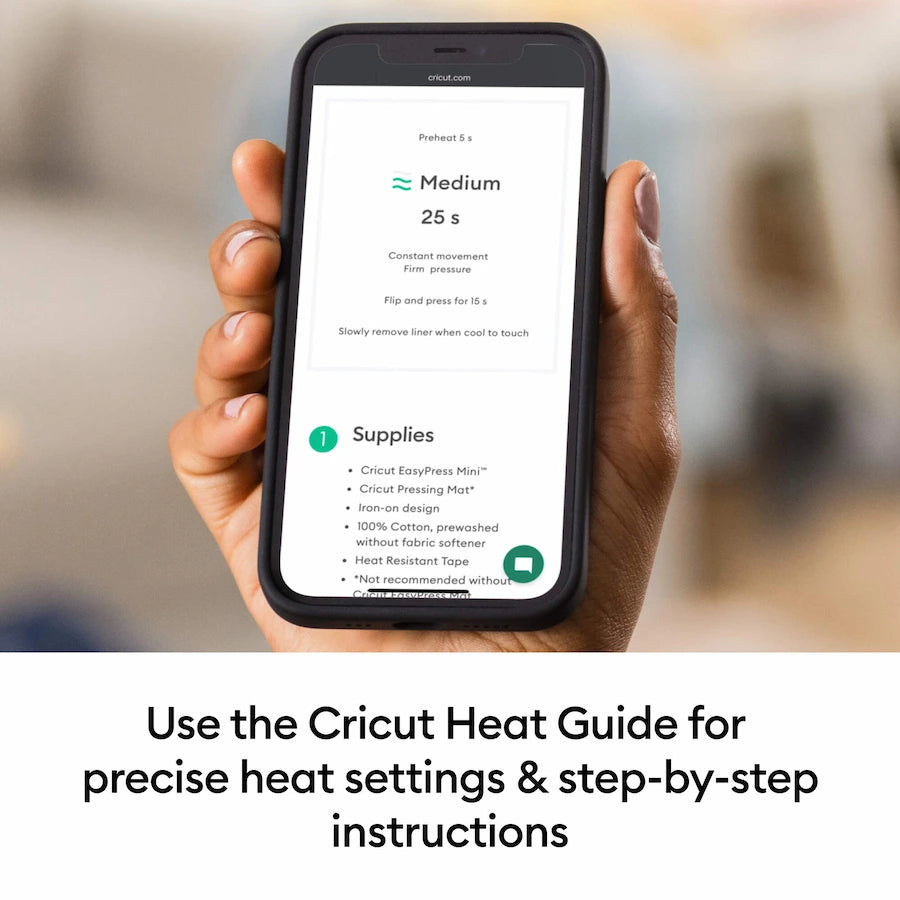 A hand holds a smartphone showing the Cricut app with heat settings and supplies, with the text 'Use the Cricut Heat Guide for precise heat settings & step-by-step instructions' below.