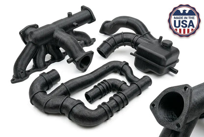 Black metal exhaust pipes with 'Made in the USA' badge on a white background