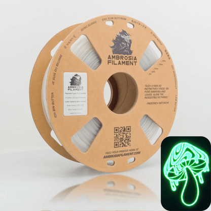 Ambrosia Galactic Sparkle PLA filament 1.75mm 1kg in GITD (Clear to Green Glow) on a cardboard spool