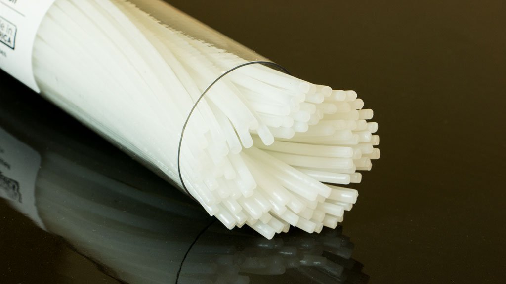 Roll of white noodles on a dark surface