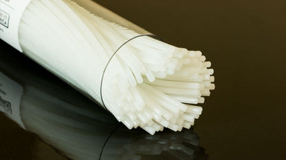 Roll of white noodles on a dark surface
