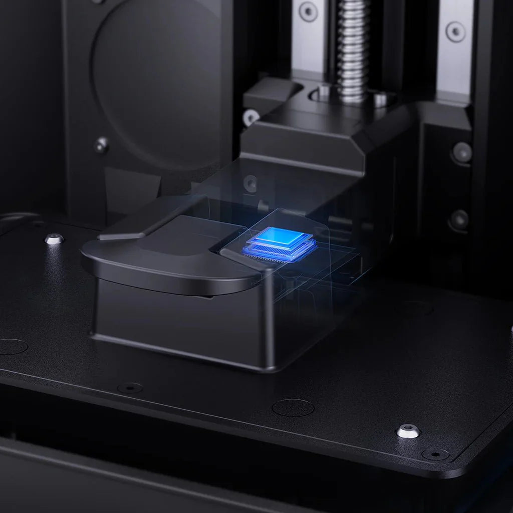 3D printer in operation with a blue light on the print bed