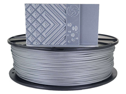 Spool of gray filament with a box labeled 'PLA' on a white background