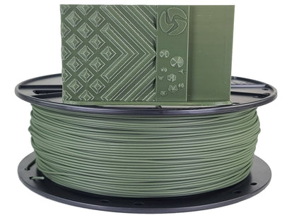 Spool of green filament with a green spool cap on a white background