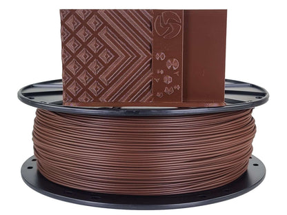 Spool of brown filament with a packaging box on top on a white background