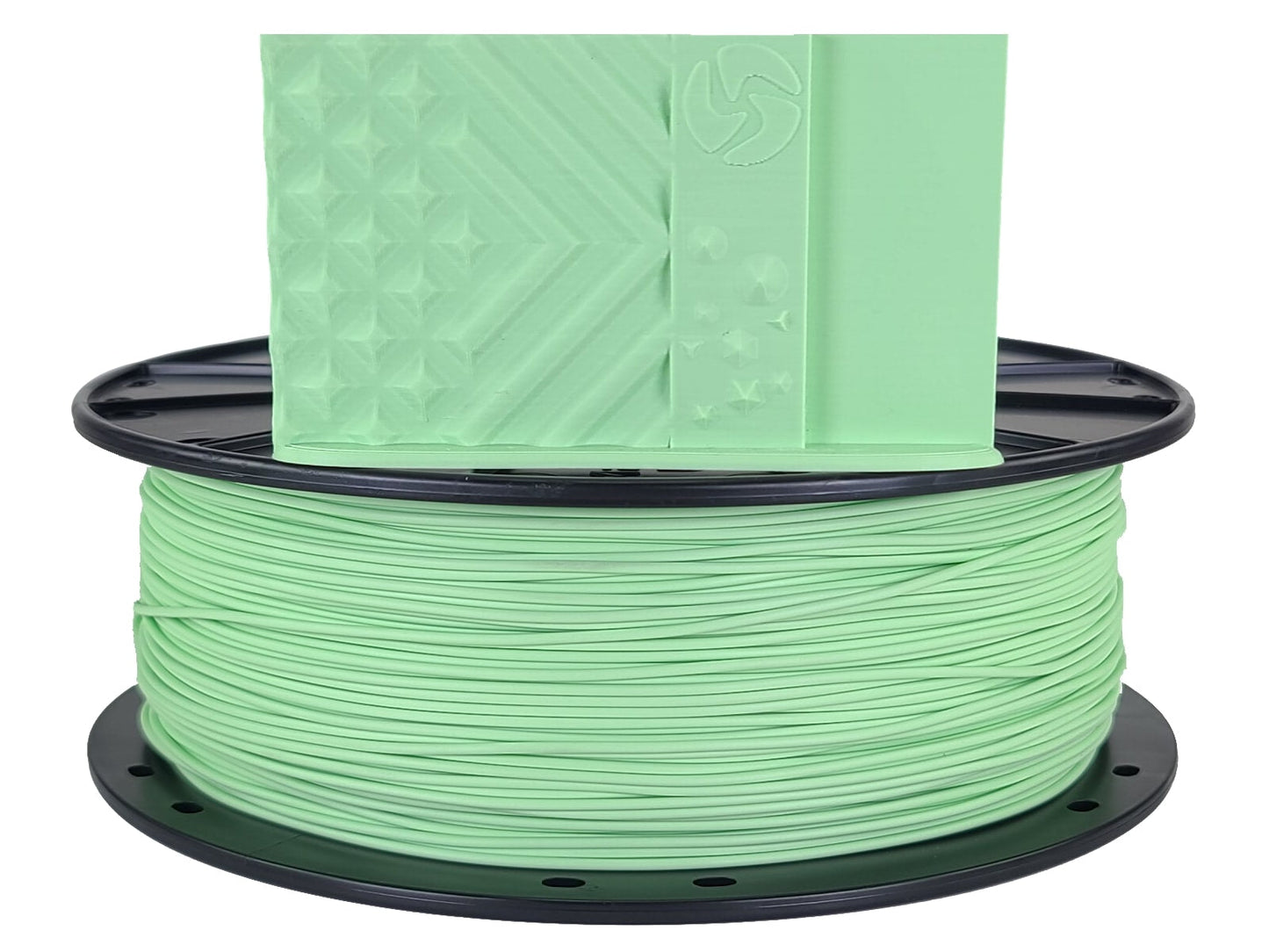 Spool of green filament on a white background