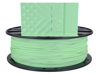 Spool of green filament on a white background