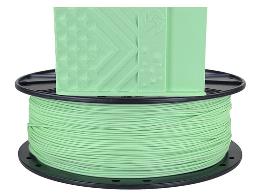Spool of green filament on a white background