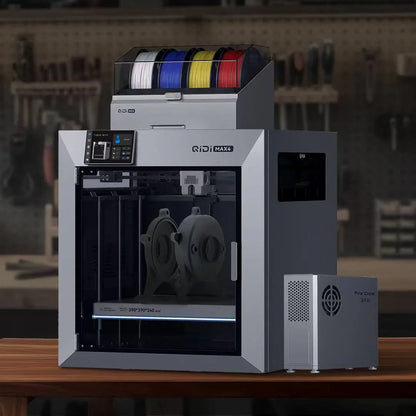 3D printer with spools of filament on a wooden table in a workshop setting