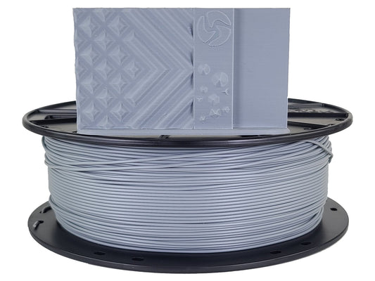 Spool of gray filament with a 3D printer nozzle on a white background