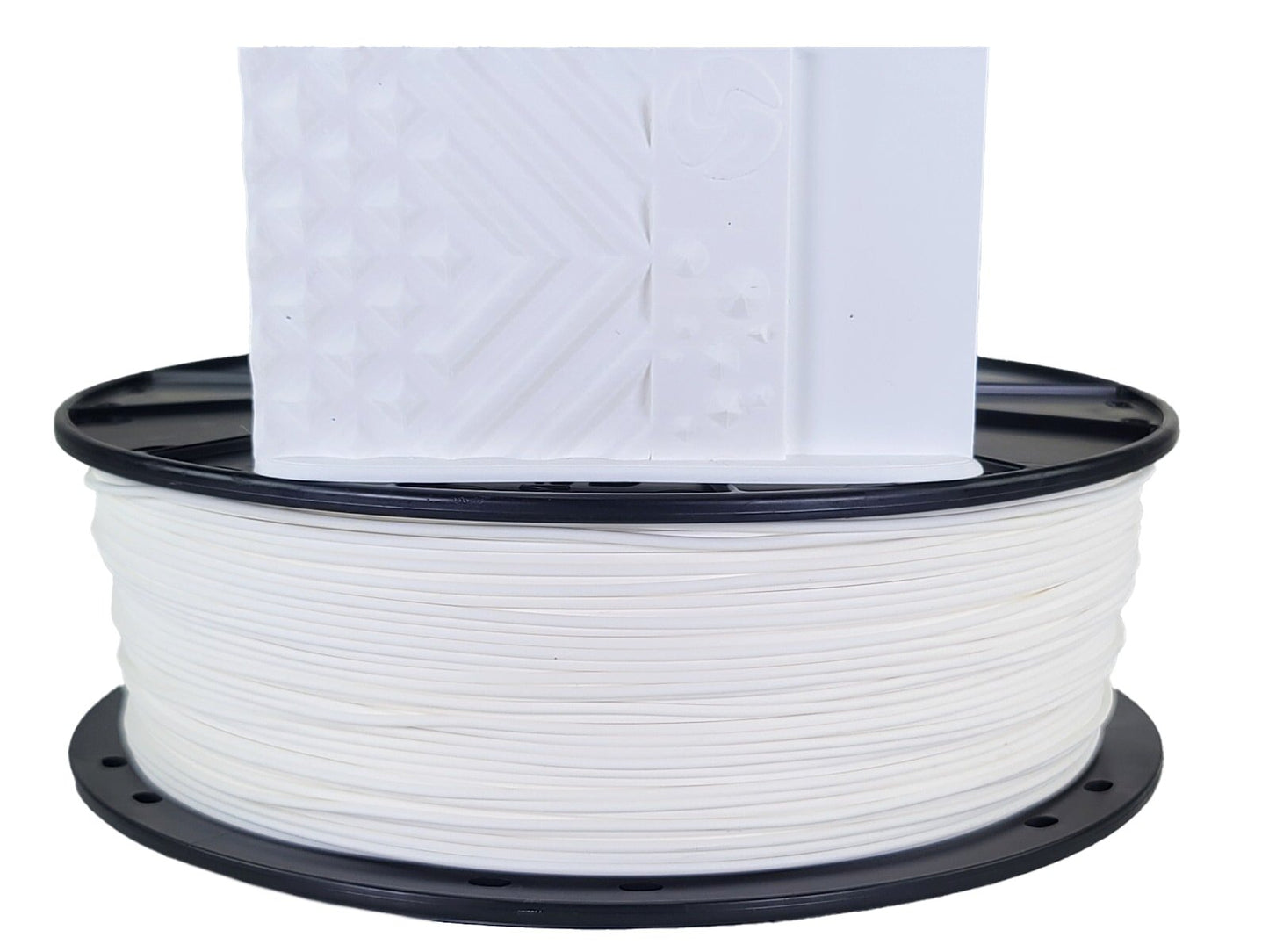 Spool of white filament with a piece of paper on top against a white background