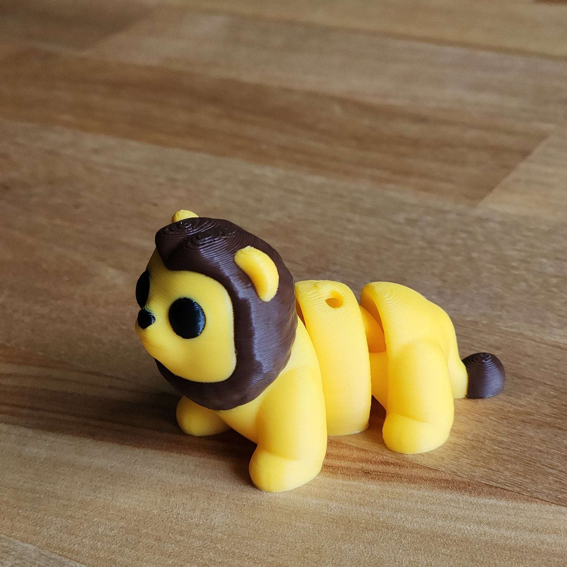 Yellow lion figurine on a wooden surface