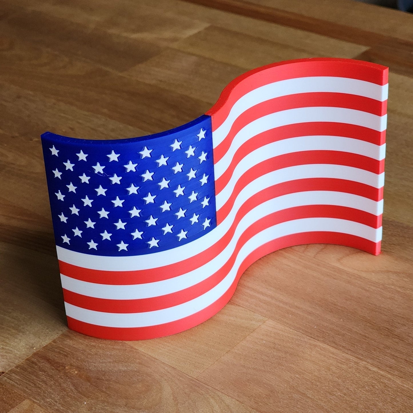 Waving American flag model on a wooden surface
